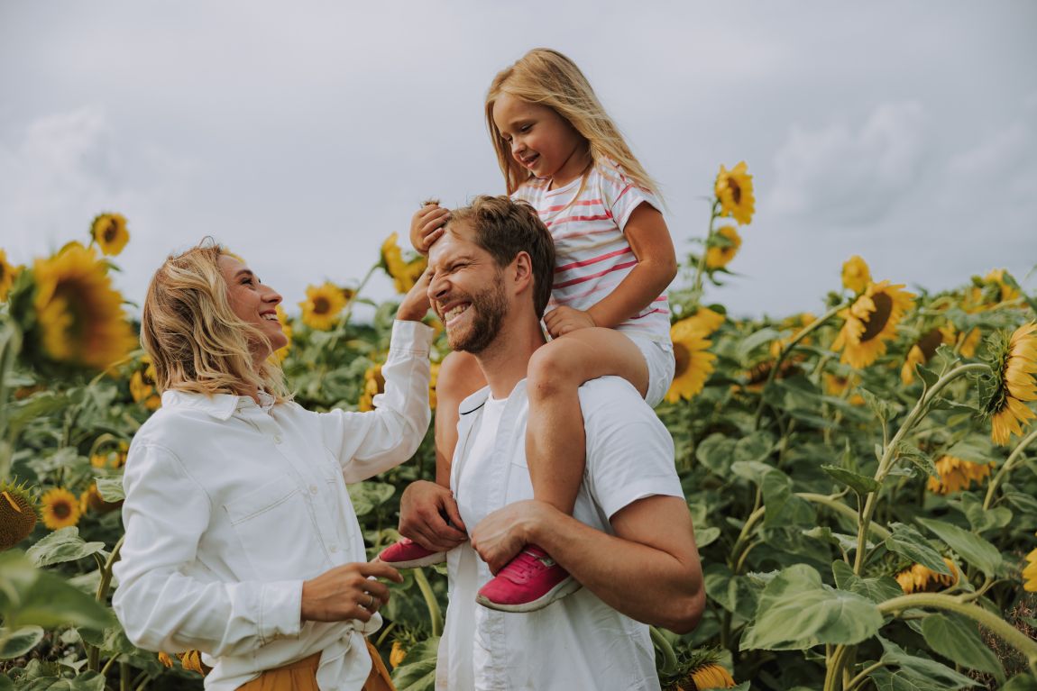 Allergy Symptoms From Plants and Grasses happy family laughing in field of sunflowers