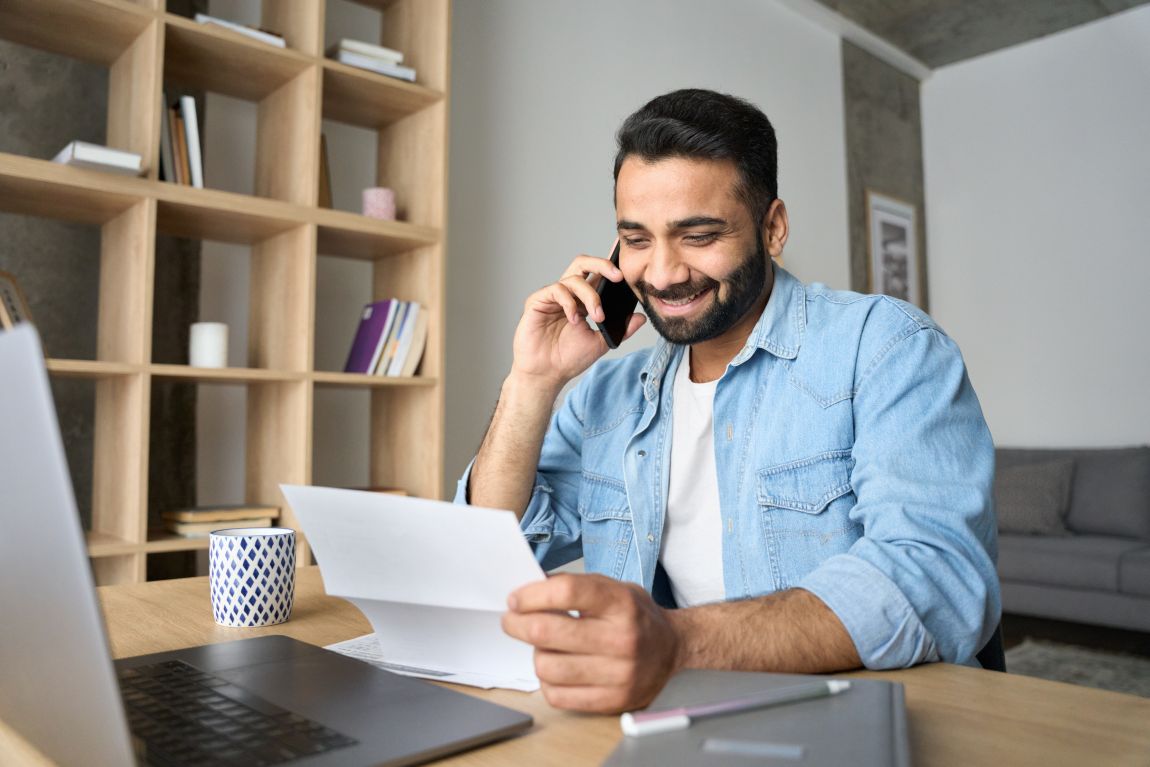 Balloon Sinuplasty Procedure man smiling on the phone while looking at paper