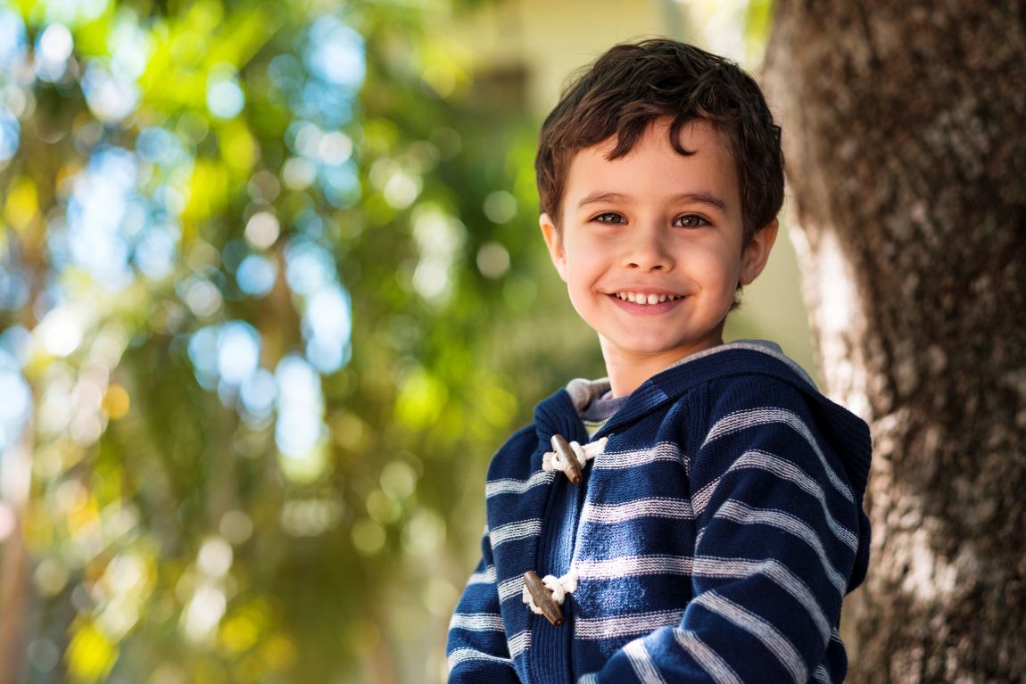Ear Tube Treatment Checkup little boy smiling by tree